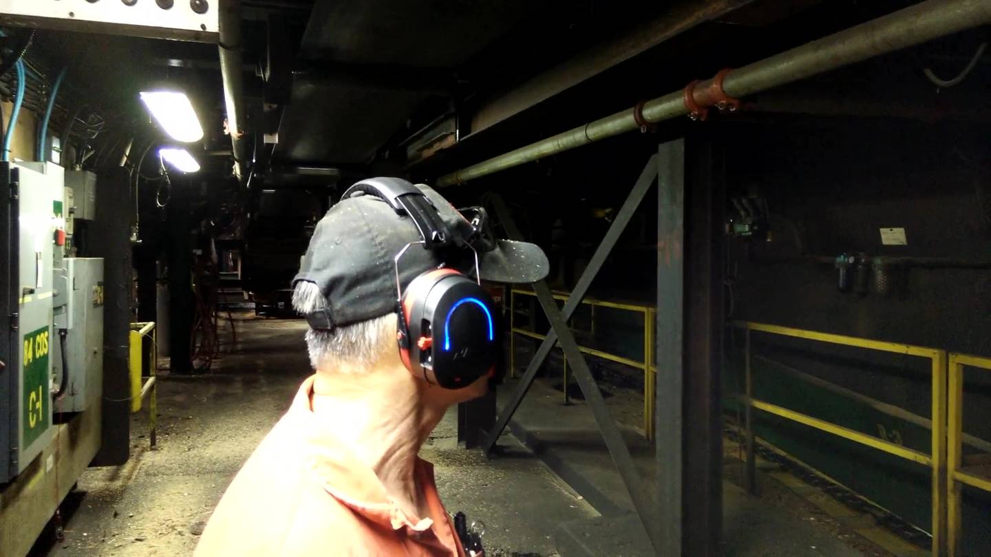 Worker in sawmill industry wearing picoMuff - picoTera's smart hearing protection earmuffs.