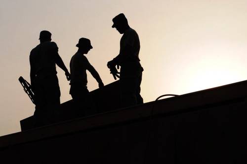 backlit photos of three workers